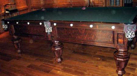 Antique, restored Phelan & Collender pool table with fretwork