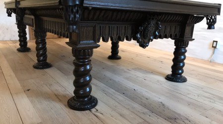 Carved details of restored Brunswick Bandes Monarch billiards table