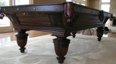 Restored Sunburst Union League billiard table with detailed carvings, leather pockets