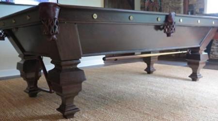 A fully restored antique billard table called "The Universal"