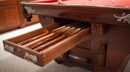 Pool cue drawer opening in the end of The Cabinet No. 2 billiards table