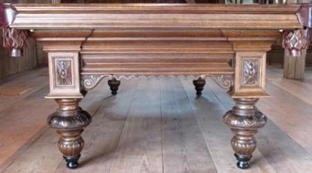Detailed carvings on a Charles Goulet billiards table, post restoration